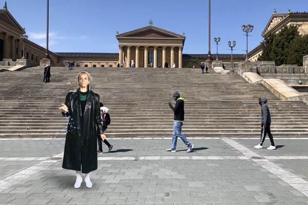 A digital image of Ursula Rucker standing at the base of the Philadelphia Art Museum steps with three people walking behind her.