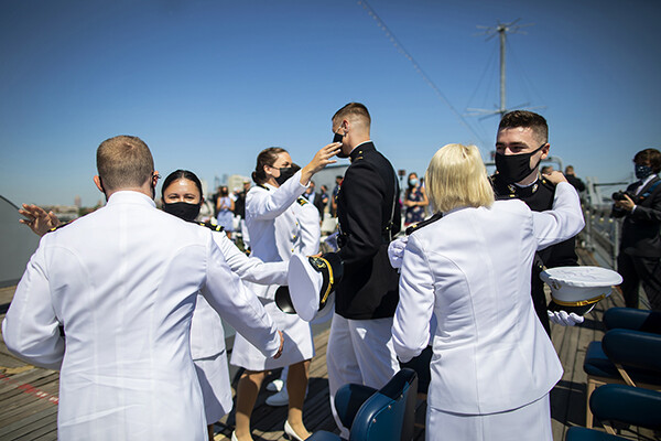 Six members of Penn’s NROTC in uniform hug aboard the USS New Jersey.
