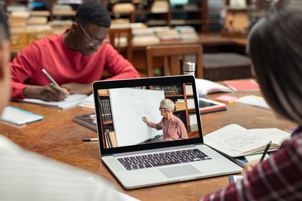 students learning virtually with laptop