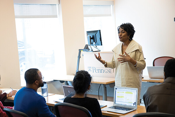 Vivian Gadsen stands at the front of a classroom speaking to students.