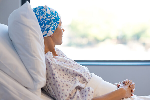 cancer patient in bed looking out window