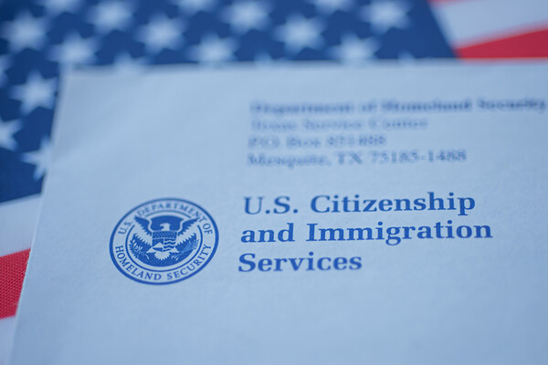 paperwork for citizenship and immigration with U.S. flag