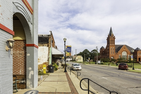 empty street of a small town Main Street with a church on one side of the street.