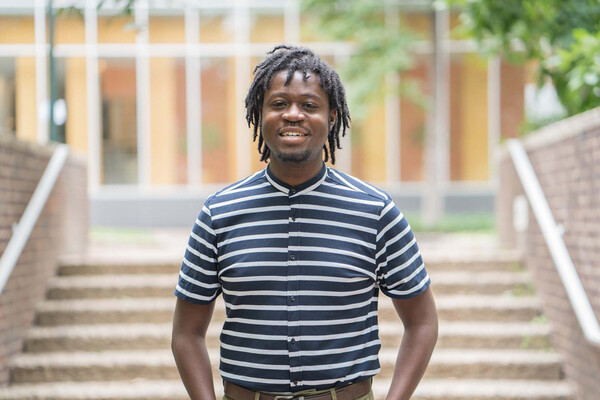 Darin Johnson stands outside in front of steps.