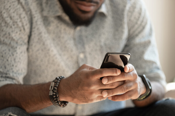 Black man looking at smartphone 