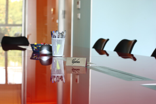 Office boardroom with a no smoking sign on the table.