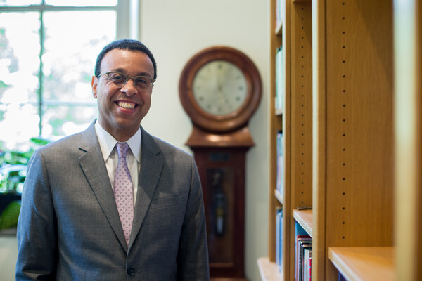 Wendell Pritchett smiles in his office