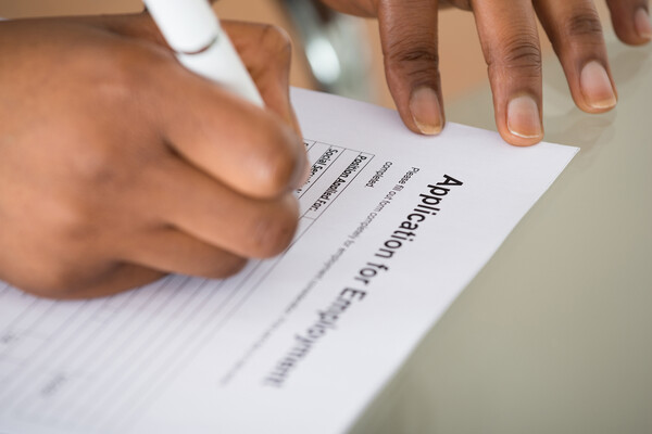 Person filling out an application.