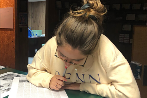 Celia Kreth reading  papers in an office in Arkansas.