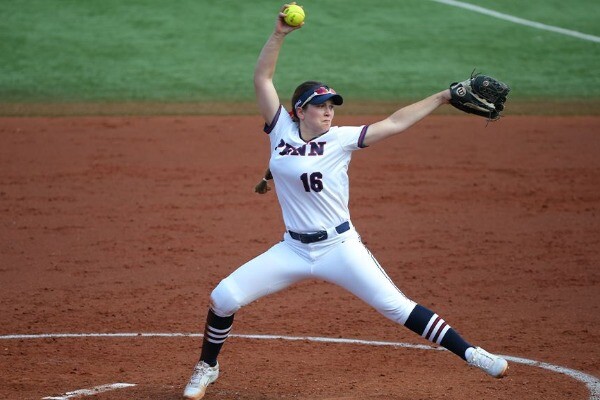 In the pitcher's circle, Bella Fiorentino prepares to throw the ball, while wearing her white Penn jersey.