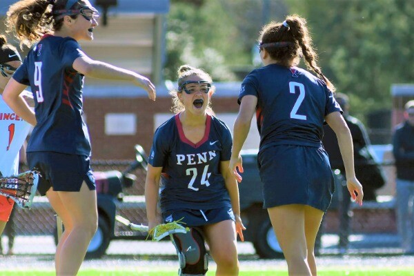 Keeley Block, center, celebrates with two of her teammates after scoring a goal.