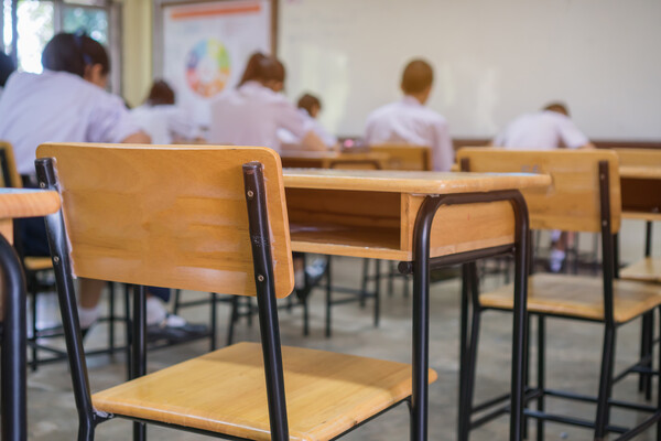 A high school classroom with several empty desks.