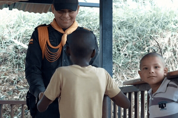 Film still of two Colombian children meeting an ex-FARC member.
