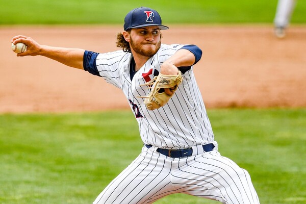 Kevin Eaise of the baseball team prepares to throw a pitch while on the mound during a game.