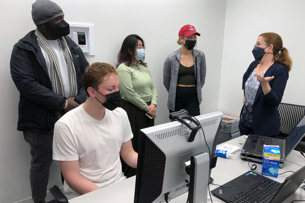 Four students and Elizabeth Johnson in a Wharton lab.