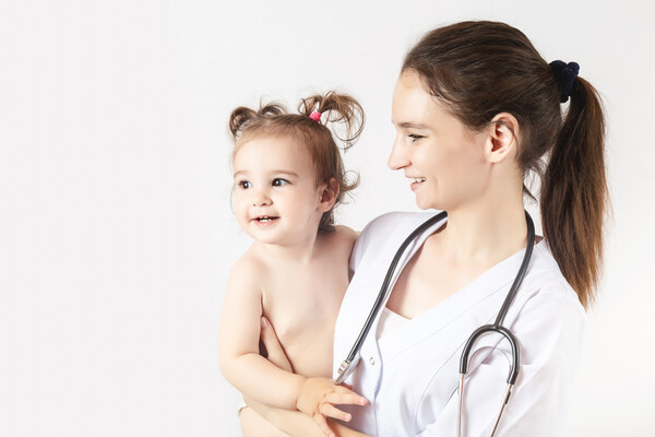 A doctor holding a baby.