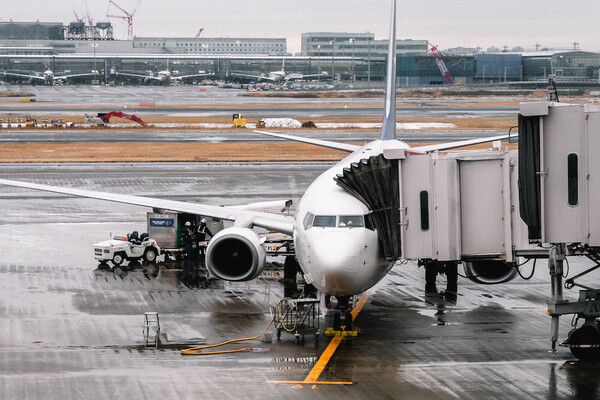Image of an airport with a plane attached to the gate