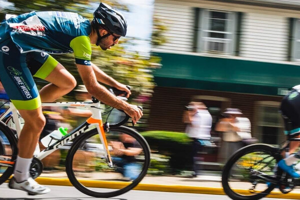 Chris Baccash racing on a bike in a cycling race.