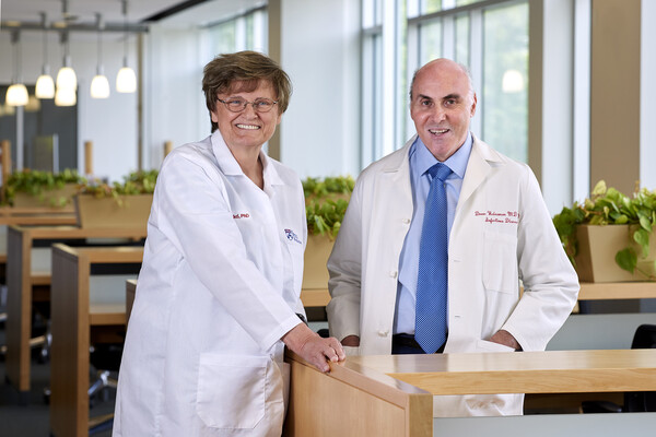 Katalin Kariko and Drew Weissman wearing lab coats.