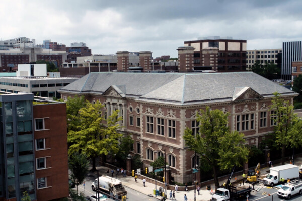 Aerial street view of a Penn law building on a city corner.