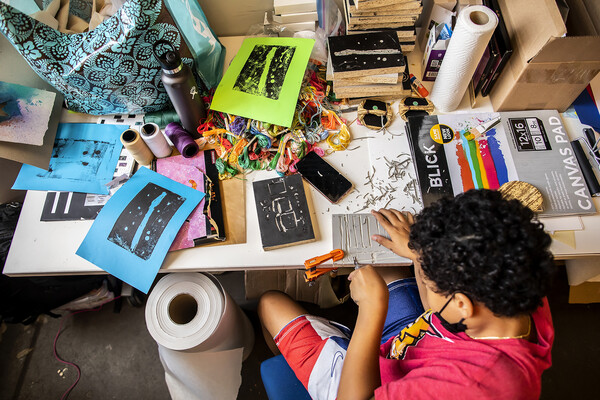 high school student working at design table