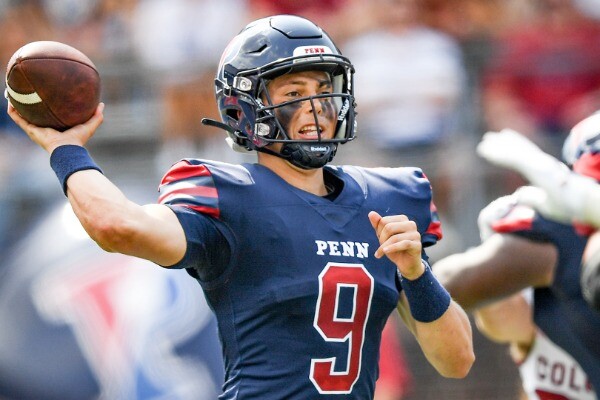 During a game, quarterback Aidan Sayin prepares to throw a pass.