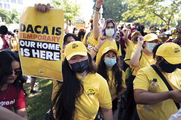 Dreamers from Mexico living in Houston rally in support of the Deferred Action for Childhood Arrivals program, holding signs reading "DACA is temporary; our home is here"