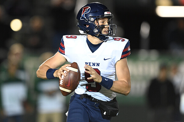 Quarterback Aidan Sayin drops back during a game and prepares to throw the ball.