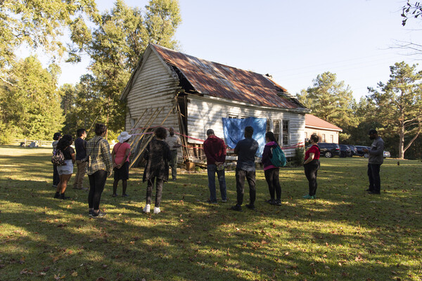 Weitzman students standing outside the St. Paul Missionary Baptist Church and The Armstrong School.