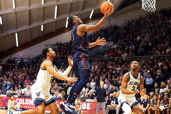 Against Villanova at Villanova, Jordan Dingle of the men's basketball team drives to the basketbal for a layup.