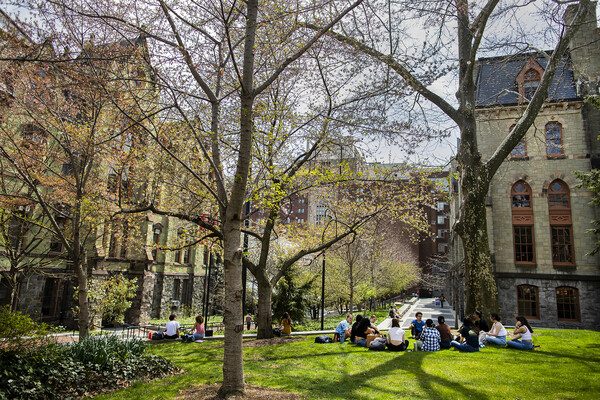 College Green in spring, a group of students are gathered on the grass.