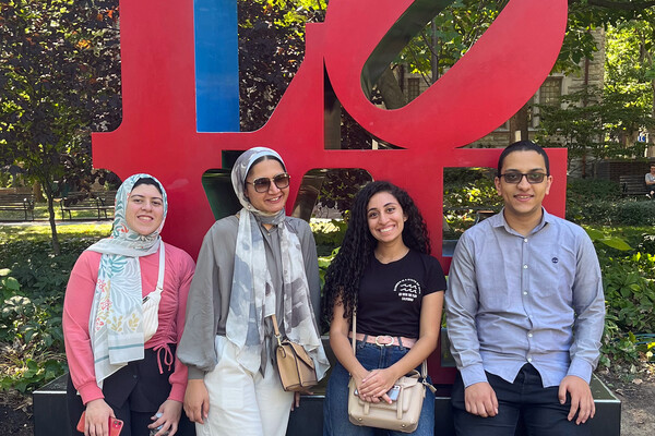 Farah Essam Girat-Allah, Rawan Sleem, Carine Mankarious, and George Habib in front of Penn’s LOVE statue on College Green.