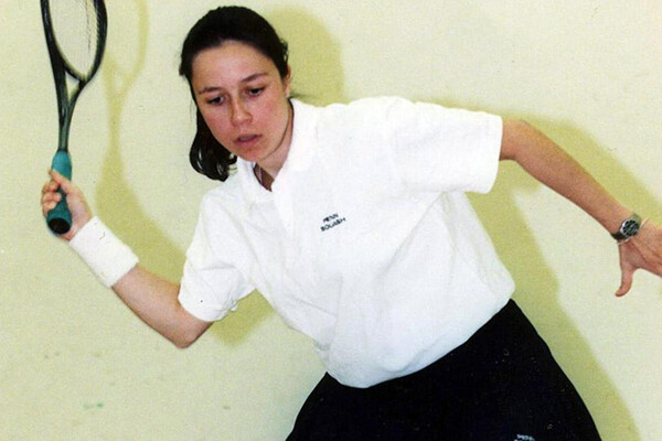 During her playing days at Penn, Jessica DiMauro prepares to swing at the ball with her squash racquet. 