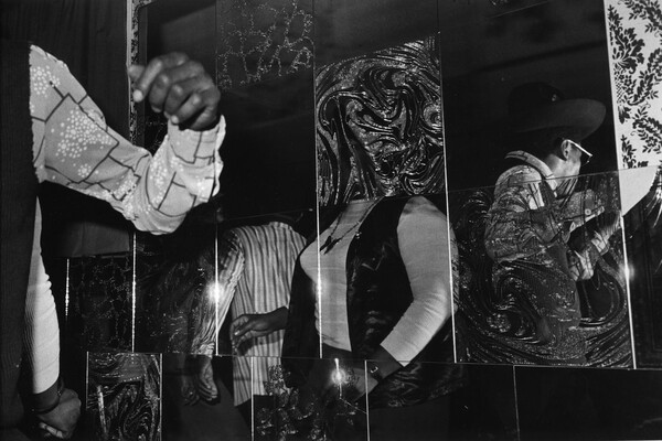 Distorted visions of people in a grid-like mirror