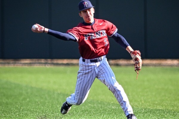 Ryan Taylor, playing left field, prepares to throw the ball to the infield during a game.