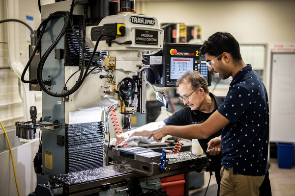 student works with mears staff member in lab