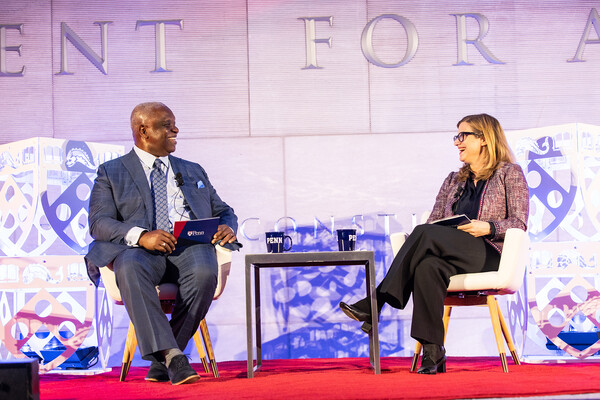 Osagie O. Imasogie and Magill laugh on stage at Constitution Center