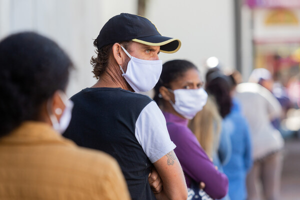 People queueing in line during the pandemic.