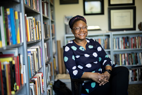 Keisha-Khan Perry in her office, surrounded by books