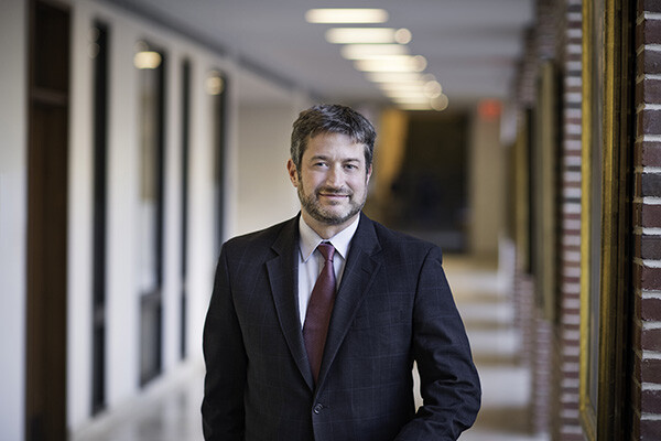 Penn Carey Law School Dean standing in a hallway of the law school building