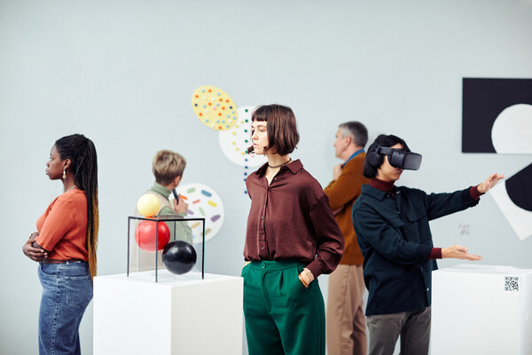 People looking at modern art in a museum or gallery setting.