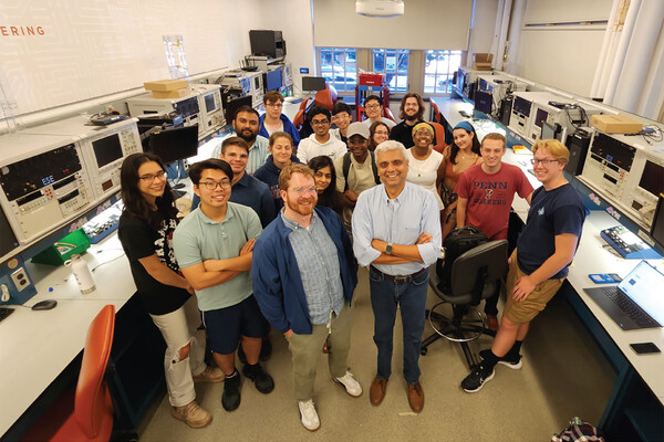 Members of the Detkin Lab in the lab surrounded by machinery.