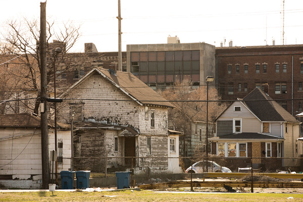 A crumbling house in an impoverished neighborhood.