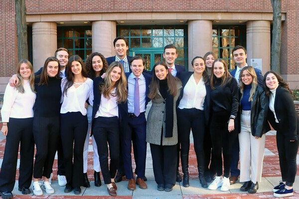 members of Wharton Latino outside a Wharton building on campus.