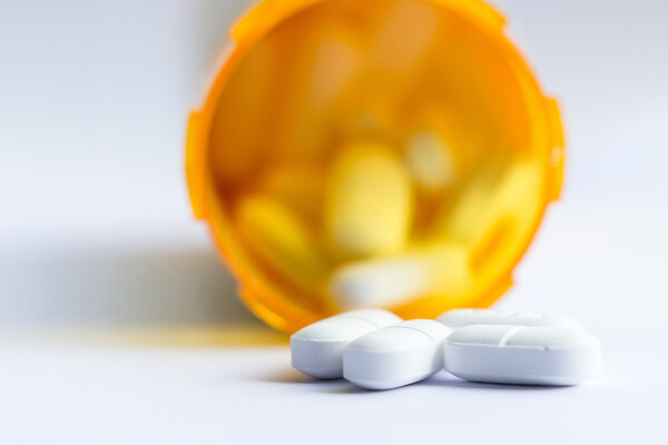An open prescription bottle of opioids.