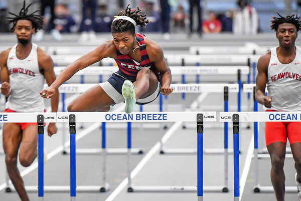 Shane Gardner leaps over a hurdle during a race in Staten Island.