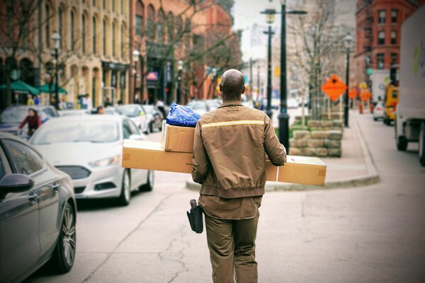 Man walking through a city carrying packages