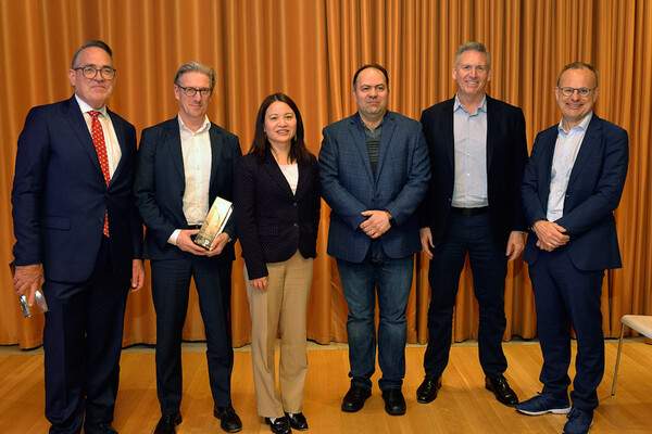 Sean McCooe, Holger Kissel, Shu Yang, Firooz Alfatouni, Steve Kelly, and Sean Marett pose for photograph at an award ceremony. 