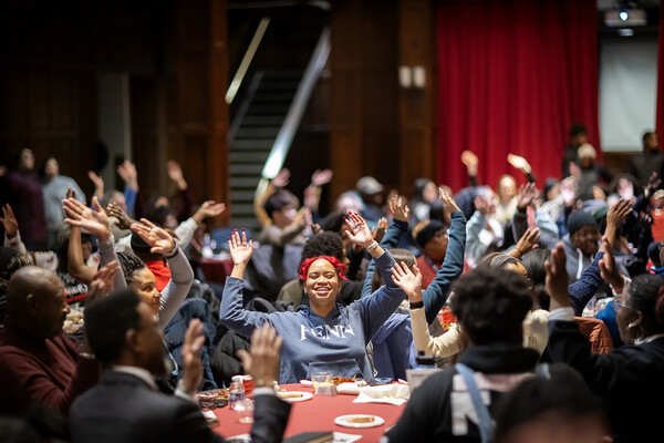 Volunteers dance during a kickoff breakfast on MLK Day