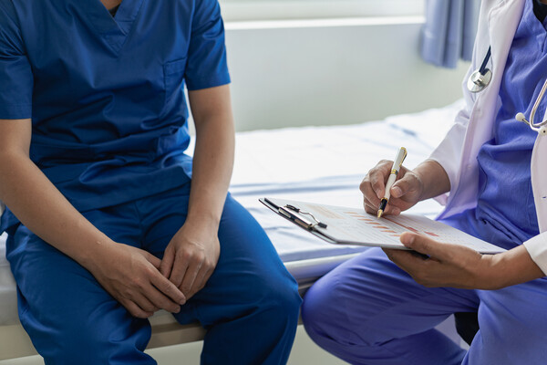 A medical professional consulting a patient.